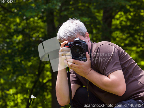 Image of male photographer photographing nature