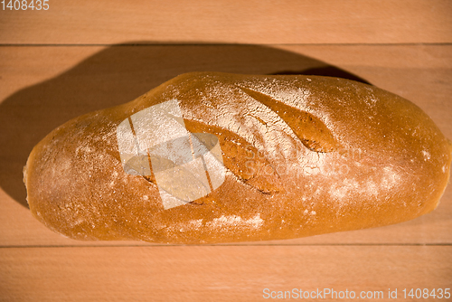 Image of fresh bread on wooden table