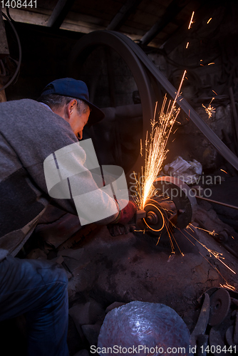 Image of the blacksmith polishing metal products