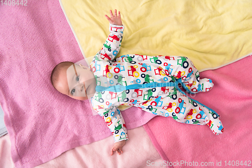 Image of top view of newborn baby boy lying on colorful blankets