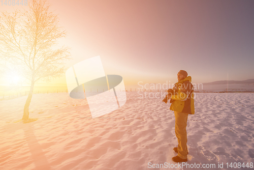Image of portrait of male photographer on sunset at winter nature