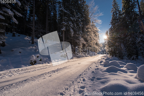 Image of Snowy country road during  sunset or sunrise