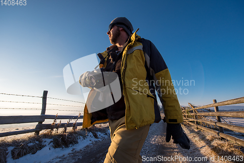 Image of young photographer walking on country road