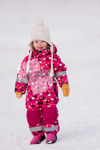 Image of little girl having fun at snowy winter day