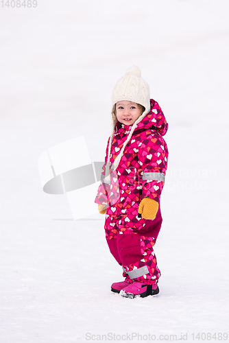 Image of little girl having fun at snowy winter day