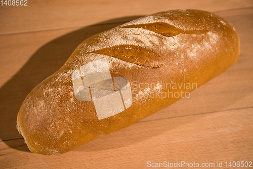 Image of fresh bread on wooden table