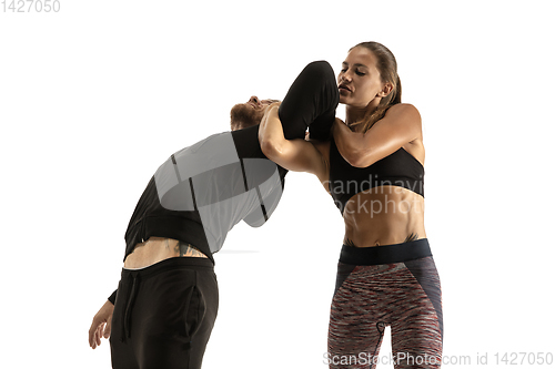 Image of Man and woman fighting in studio, women\'s self-defense concept