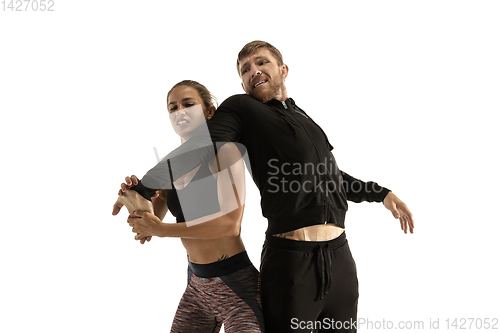 Image of Man and woman fighting in studio, women\'s self-defense concept