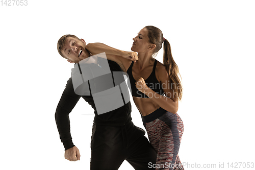 Image of Man and woman fighting in studio, women\'s self-defense concept