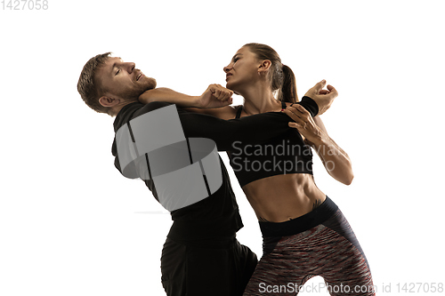 Image of Man and woman fighting in studio, women\'s self-defense concept