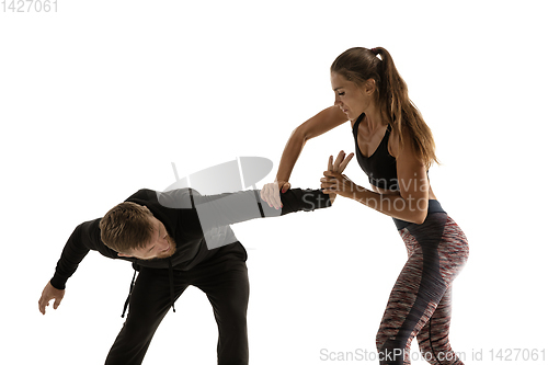 Image of Man and woman fighting in studio, women\'s self-defense concept