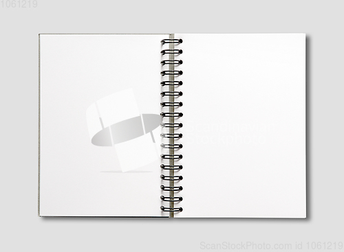 Image of Blank open spiral notebook isolated on grey