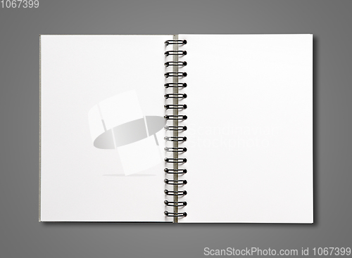 Image of Blank open spiral notebook isolated on dark grey