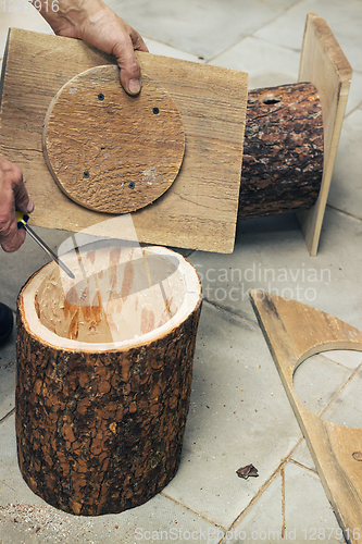 Image of Carpenter closes the cover birdhouse