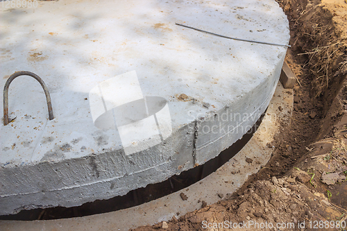 Image of Massive concrete cap installed on the well