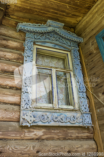 Image of Window of an old house with carved platbands