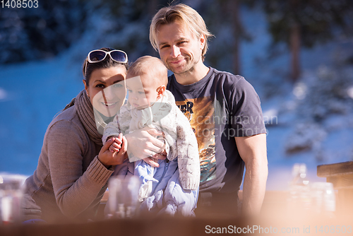 Image of young happy family with little child enjoying winter day