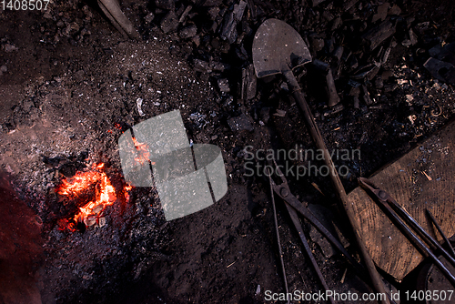 Image of top view of traditional blacksmith furnace with burning fire