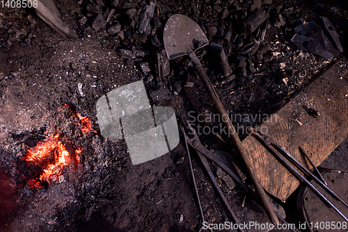 Image of top view of traditional blacksmith furnace with burning fire