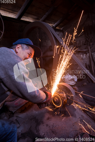 Image of the blacksmith polishing metal products