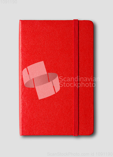 Image of Red closed notebook isolated on grey