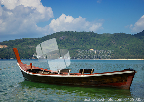 Image of Thai wooden boat on a calm sea bay