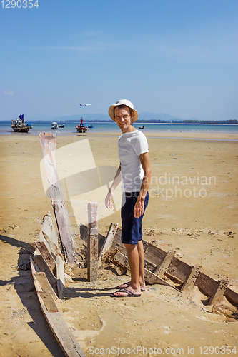 Image of Happy camper standing on the shattered boat