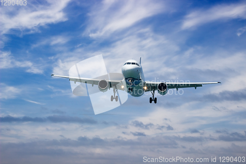 Image of Airplane landing at sunset