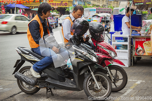 Image of Taxi drivers on scooters waiting for customers. Thailand