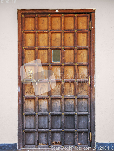 Image of Old wooden door with a bronze lock