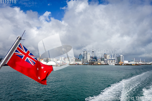 Image of Auckland view from the sea and New Zealand civil flag