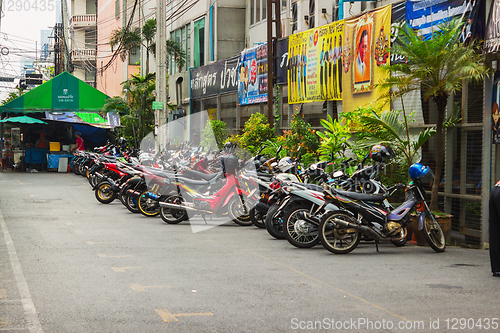 Image of Scooters parked along the street in town. Bangkok