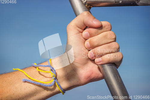 Image of Hand on handrail in ship sailing