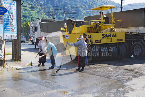 Image of People are working on repairing the road