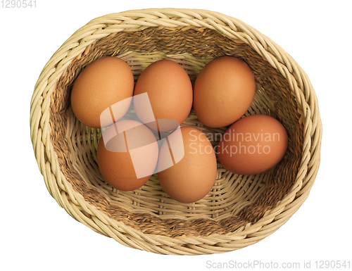 Image of Eggs in wicker basket on white background, top view