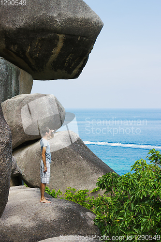 Image of Camper man on the cliff and looks into the distance