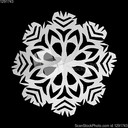 Image of On black background lie white snowflake, cut from paper