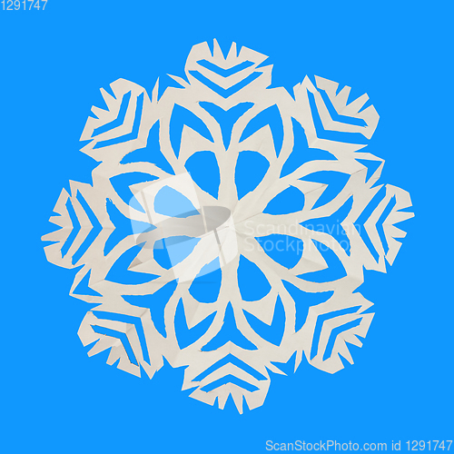 Image of On blue background lie one paper snowflake