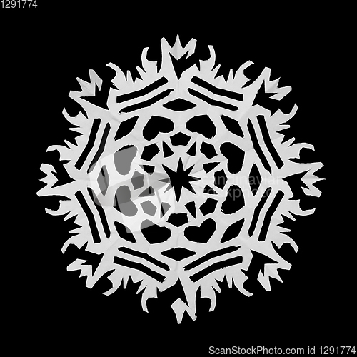 Image of On a black background lie a paper snowflake