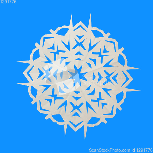 Image of Paper white snowflake lie on blue background