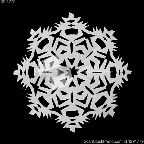 Image of Snowflake from paper and lies on black background