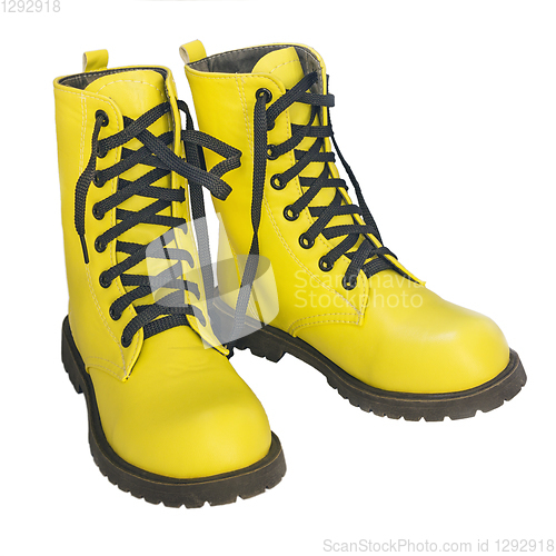Image of Yellow shoes with black lacing on white background