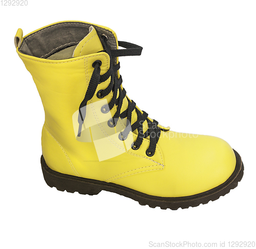 Image of One high yellow boot with black lacing on white background