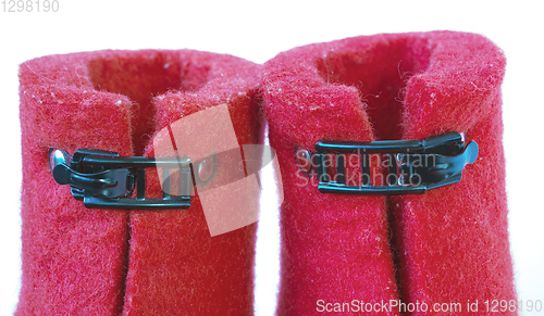 Image of Iron clasps on the felt red boots white background