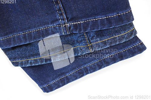 Image of Thread seam on blue denim trousers on white background