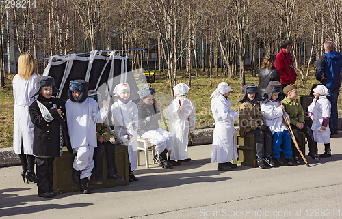 Image of Children participate in staging immortal Regiment. Polyarnye Zori. Russia