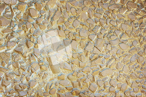 Image of Concrete panel surface is covered with gravel, painted in brown