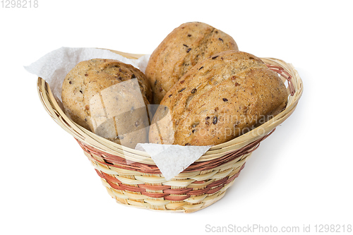 Image of Three oatmeal buns in a small basket, white background