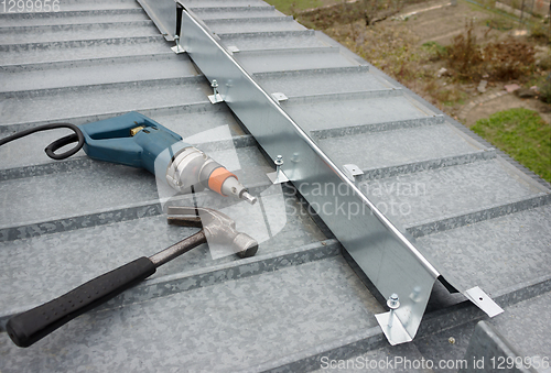 Image of It made a barrier to the snow guard on the roof edge