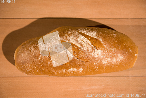 Image of fresh bread on wooden table